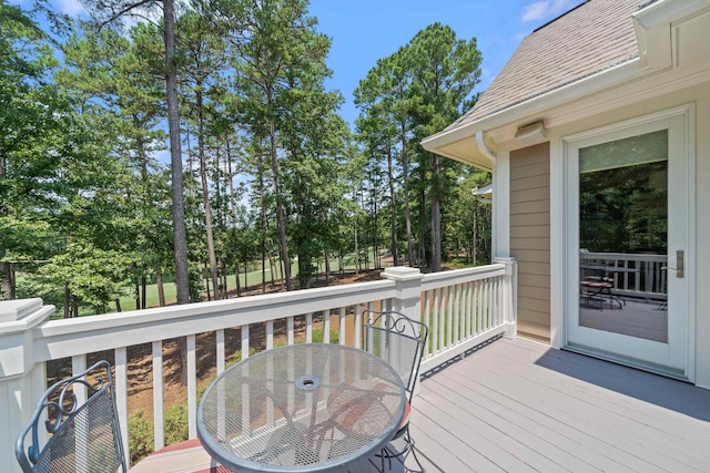 1191 Linger Longer Dr, Greensboro, GA 30642 - wooden terrace with outdoor dining area and view of wooded area
