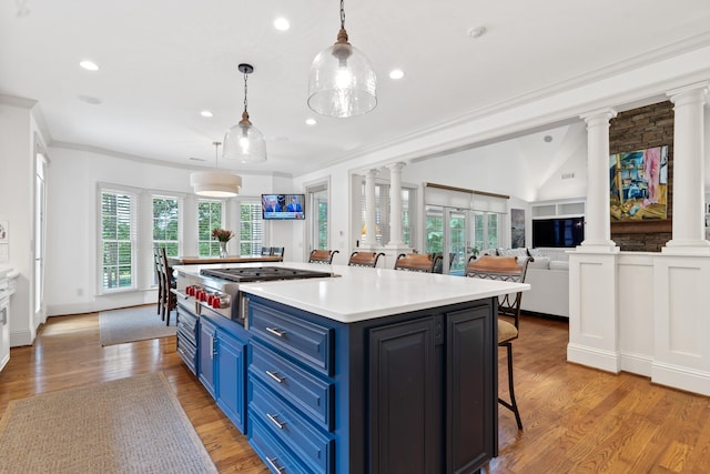 1191 Linger Longer Dr, Greensboro, GA 30642 - kitchen featuring ornate columns, blue cabinetry, stainless steel gas cooktop, a breakfast bar area, and recessed lighting