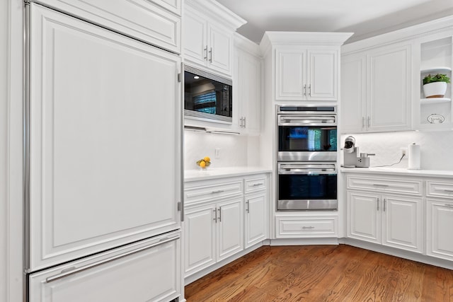 1191 Linger Longer Dr, Greensboro, GA 30642 - kitchen with built in appliances, open shelves, white cabinetry, wood finished floors, and light countertops
