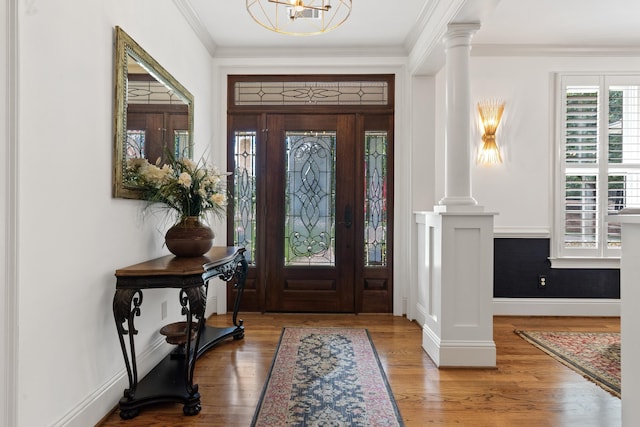 1191 Linger Longer Dr, Greensboro, GA 30642 - entrance foyer featuring decorative columns, wood finished floors, crown molding, and a chandelier