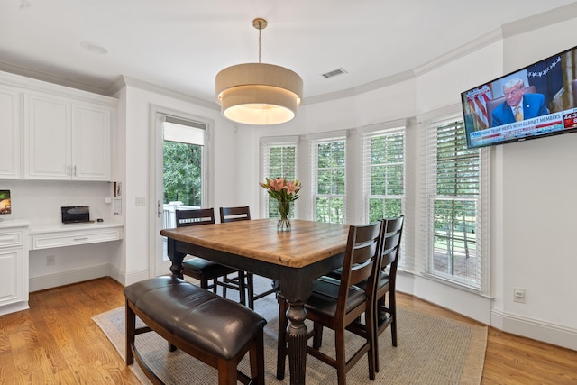 1191 Linger Longer Dr, Greensboro, GA 30642 - dining area featuring light wood finished floors and crown molding