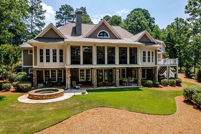 1191 Linger Longer Dr, Greensboro, GA 30642 - back of property featuring a chimney, an in-ground hot tub, a lawn, and stairs