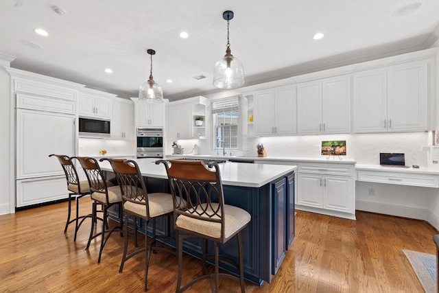 1191 Linger Longer Dr, Greensboro, GA 30642 - kitchen with black microwave, white cabinets, recessed lighting, a center island, and open shelves