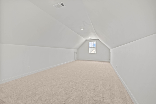 bonus room featuring vaulted ceiling, carpet flooring, visible vents, and baseboards