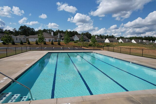 pool featuring a residential view and fence