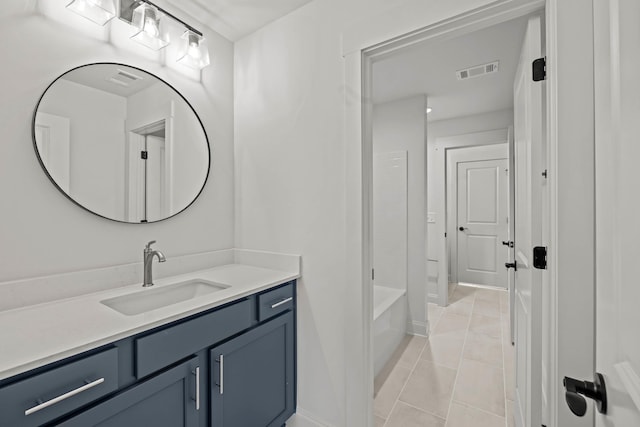 bathroom with baseboards, vanity, visible vents, and tile patterned floors