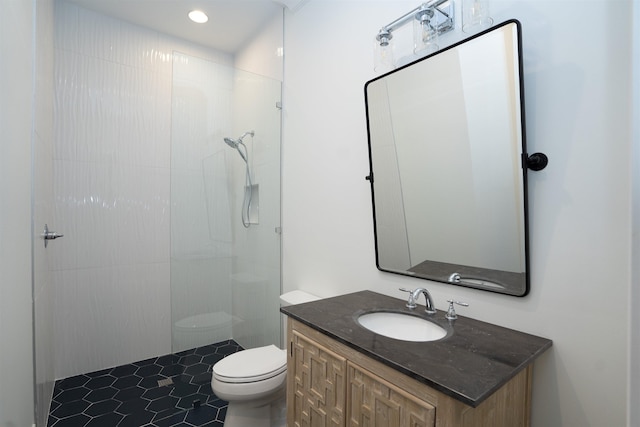 bathroom featuring vanity, a shower, and toilet