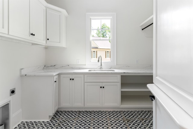 clothes washing area featuring sink and hookup for an electric dryer