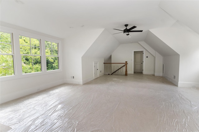 additional living space with ceiling fan and vaulted ceiling