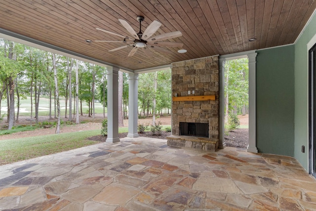 view of patio featuring ceiling fan and an outdoor stone fireplace