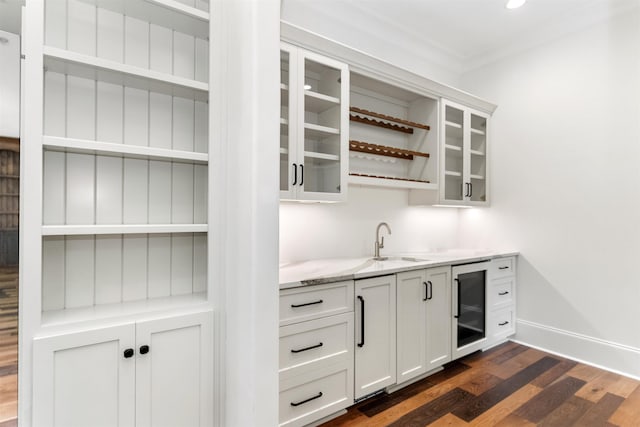 bar featuring sink, white cabinetry, wine cooler, light stone countertops, and dark hardwood / wood-style flooring