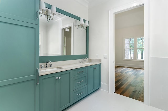 bathroom with hardwood / wood-style flooring, vanity, and crown molding