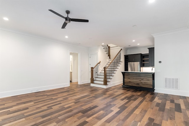 unfurnished living room featuring ceiling fan and ornamental molding