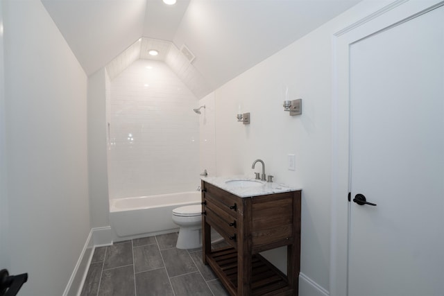 full bathroom with tiled shower / bath combo, vaulted ceiling, vanity, and toilet