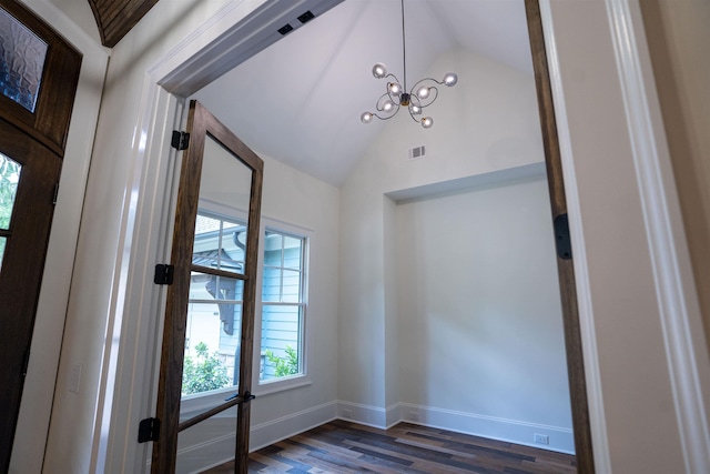 interior space with lofted ceiling, dark hardwood / wood-style floors, and a notable chandelier