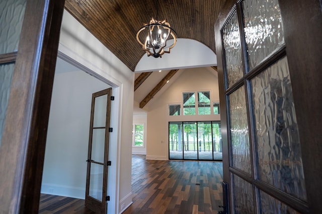 hallway with dark hardwood / wood-style floors, high vaulted ceiling, beam ceiling, and a notable chandelier