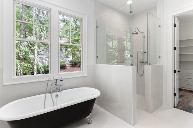 bathroom with hardwood / wood-style flooring and separate shower and tub