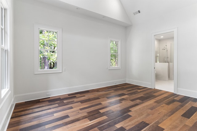 unfurnished bedroom featuring multiple windows, high vaulted ceiling, and dark hardwood / wood-style flooring