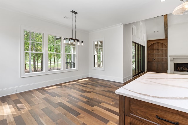 unfurnished dining area featuring crown molding and dark wood-type flooring