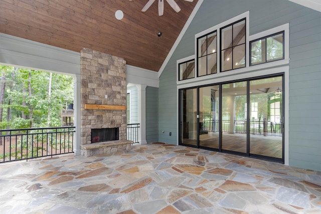 view of patio / terrace featuring ceiling fan and an outdoor stone fireplace