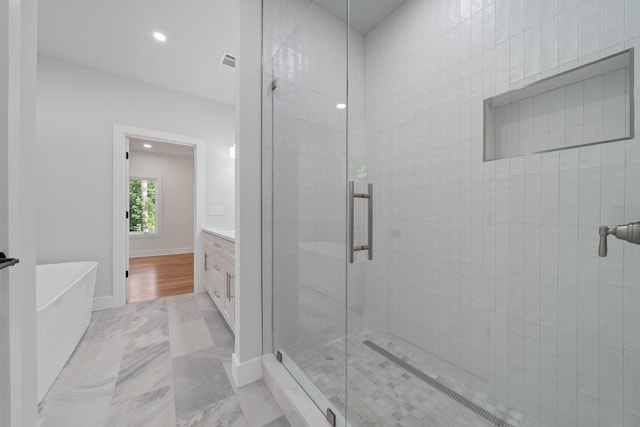 631 Susan Davis Rd, Sparta, GA 31087 - full bath with a stall shower, vanity, a freestanding tub, recessed lighting, and marble finish flooring