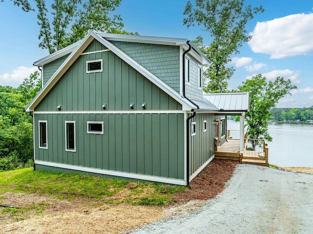 631 Susan Davis Rd, Sparta, GA 31087 - view of home's exterior featuring dirt driveway, a deck with water view, board and batten siding, and metal roof