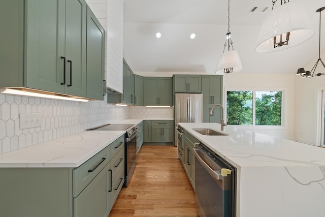 631 Susan Davis Rd, Sparta, GA 31087 - kitchen with stainless steel appliances, green cabinetry, a sink, light wood-style flooring, and decorative backsplash