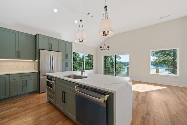 631 Susan Davis Rd, Sparta, GA 31087 - kitchen featuring appliances with stainless steel finishes, a sink, green cabinetry, pendant lighting, and decorative backsplash