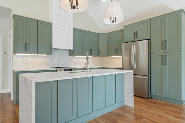 631 Susan Davis Rd, Sparta, GA 31087 - kitchen featuring freestanding refrigerator, a sink, backsplash, light wood-type flooring, and lofted ceiling