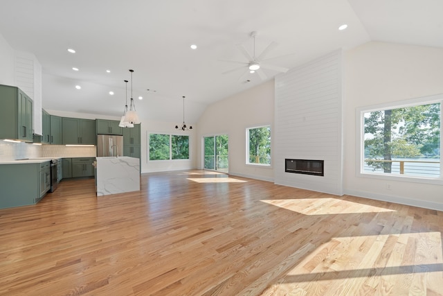 631 Susan Davis Rd, Sparta, GA 31087 - unfurnished living room with a ceiling fan, recessed lighting, a large fireplace, light wood-style floors, and high vaulted ceiling