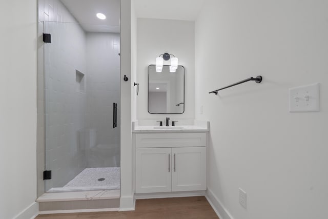 631 Susan Davis Rd, Sparta, GA 31087 - bathroom featuring a stall shower, wood finished floors, vanity, baseboards, and recessed lighting