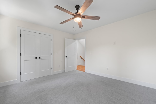 631 Susan Davis Rd, Sparta, GA 31087 - unfurnished bedroom with light carpet, baseboards, a closet, and ceiling fan