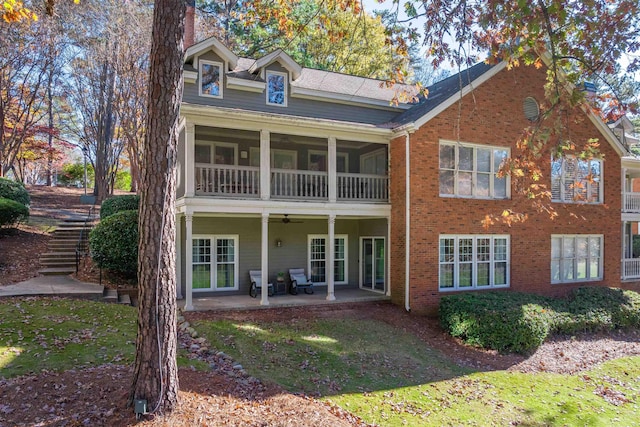 back of property featuring a lawn, ceiling fan, and a patio area