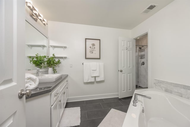 bathroom with vanity, tile patterned floors, and plus walk in shower