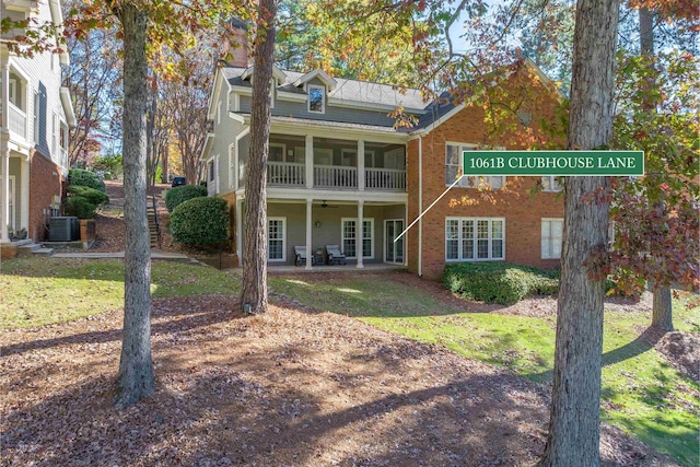 back of property featuring central AC unit, a yard, and ceiling fan