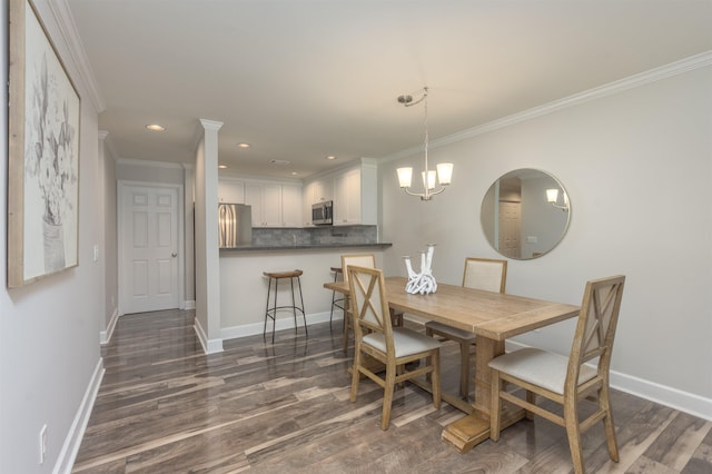 dining area featuring dark wood-type flooring, crown molding, and a notable chandelier