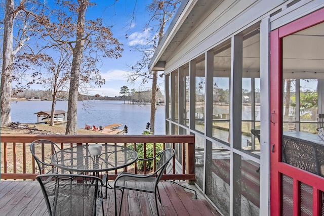 wooden deck with a water view and a sunroom