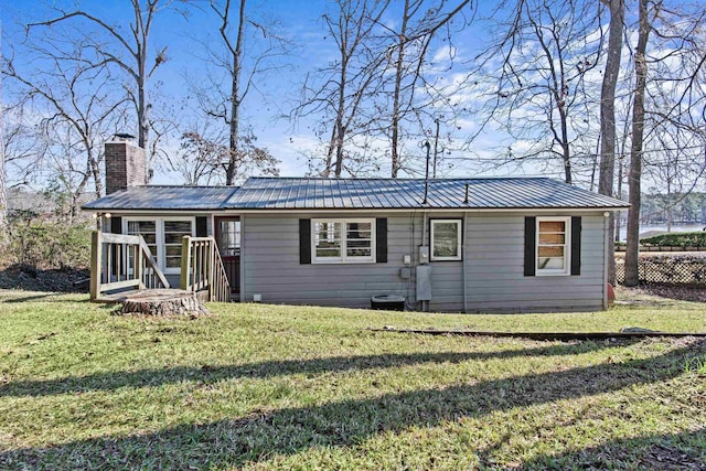 view of front facade featuring a front yard and a sunroom