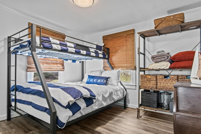 bedroom with hardwood / wood-style flooring and ornamental molding