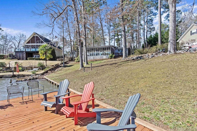 deck featuring a yard and a sunroom