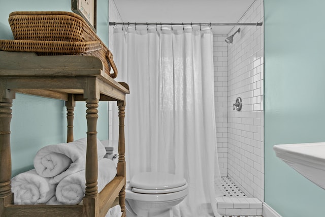 bathroom with sink, toilet, and walk in shower