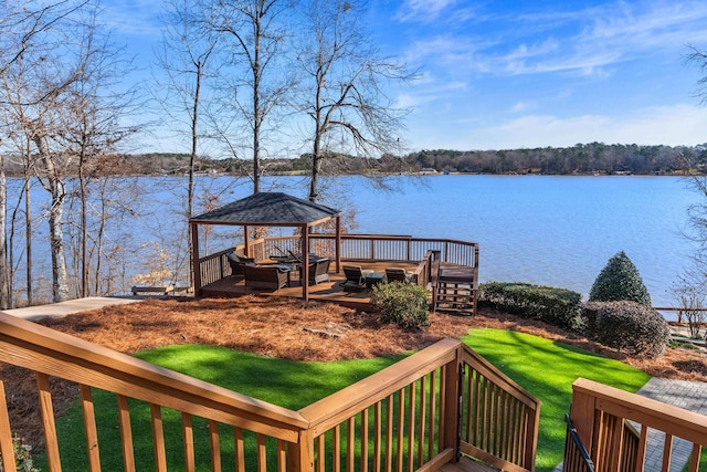 deck featuring a water view, a yard, and a gazebo