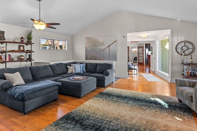 living area featuring ceiling fan, vaulted ceiling, and wood finished floors