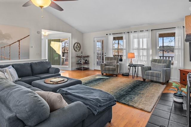 living area featuring a healthy amount of sunlight, light wood-style flooring, ceiling fan, and lofted ceiling