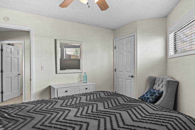 bedroom with light carpet and ceiling fan