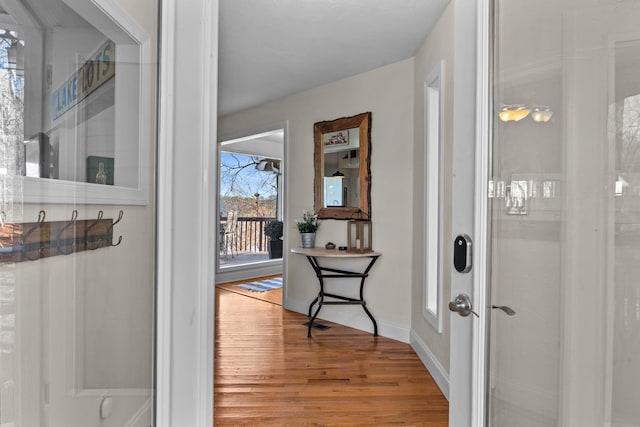 hallway featuring baseboards and wood finished floors