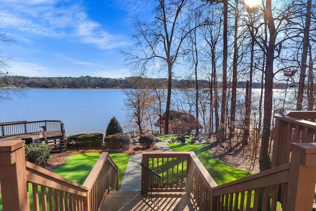 wooden deck featuring a yard and a water view