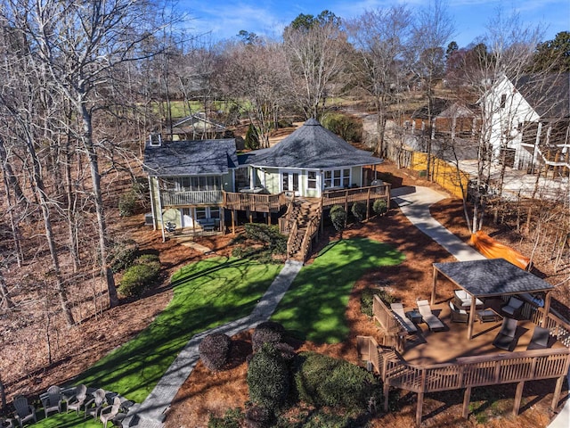 back of house featuring a shingled roof, a wooden deck, and an outdoor living space