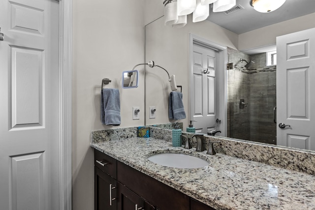 bathroom featuring a shower stall, visible vents, and vanity