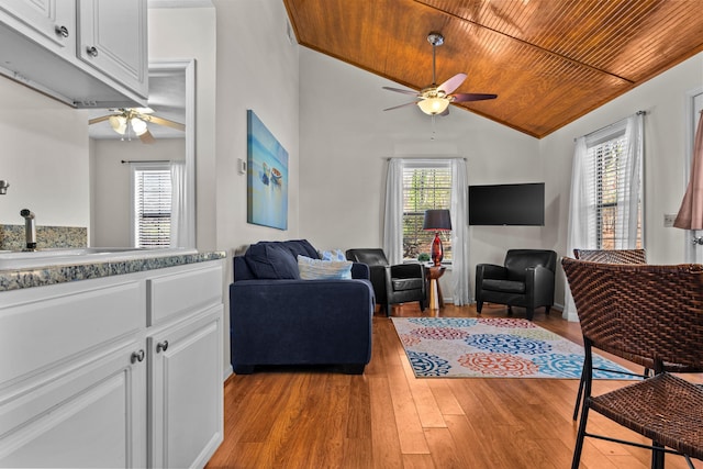 living room with wooden ceiling, plenty of natural light, ceiling fan, and light wood-style floors